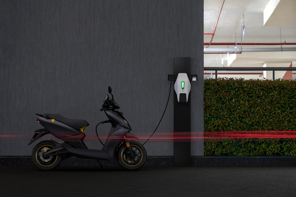 An electric bike plugged into a charging outlet