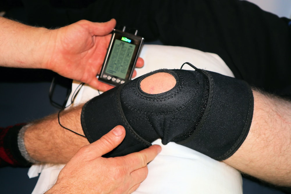 A person having their knee injury monitored